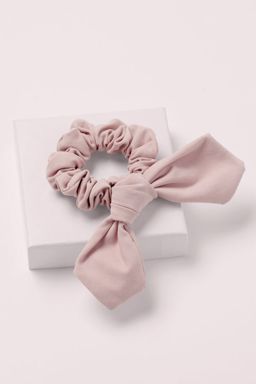 Bow Pose Knotted Ribbon Scrunchie on a pink box