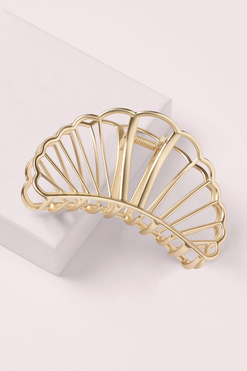 The Hair Edit Large Gold Gilded Mermaid Shell Claw Clip on a pink box