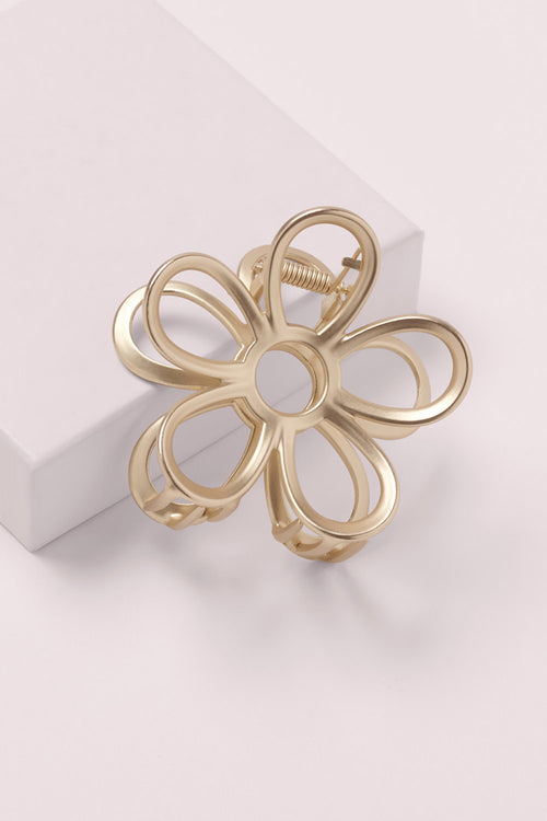 Gilded Secret Garden Flower Claw Clip on a pink box