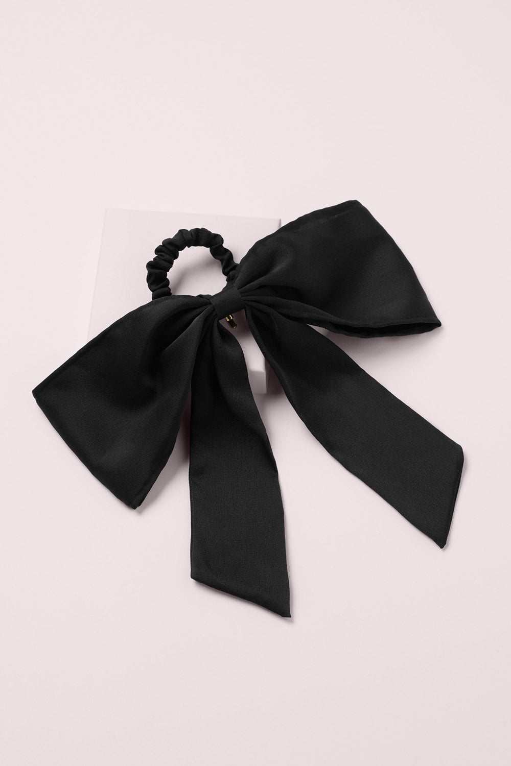 Runway Ribbon Satin Hair Bow on a pink box