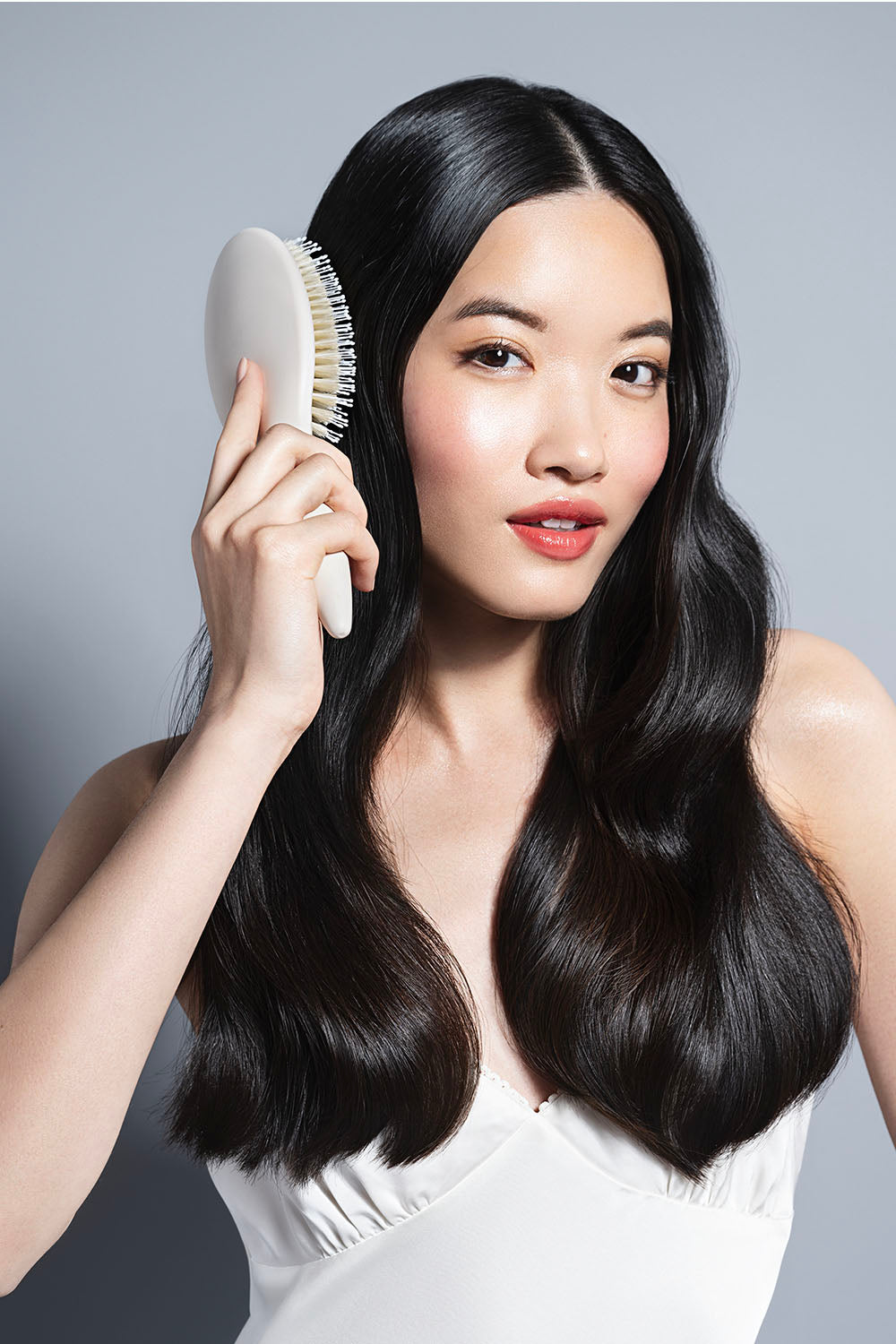 model brushing her black hair