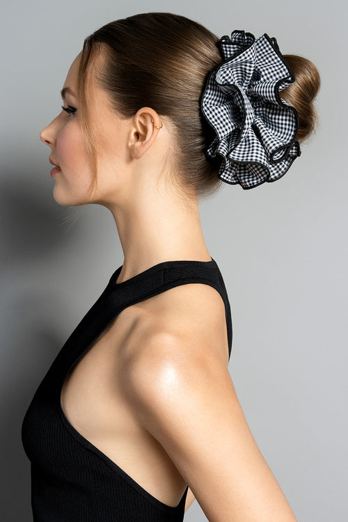 Brunette model wearing Black and white gingham oversized ruffled scrunchie in her hair