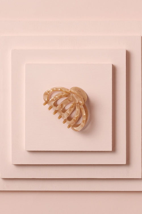 Jellyfish Claw Clip on a stack of pink boxes