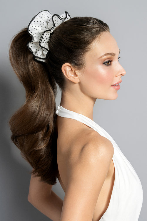 Brunette model wearing oversized scrunchie in her ponytail