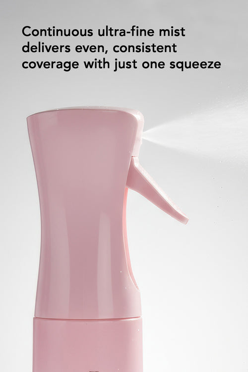 Pink spray bottle with text about ultra-fine mist on a light gray background