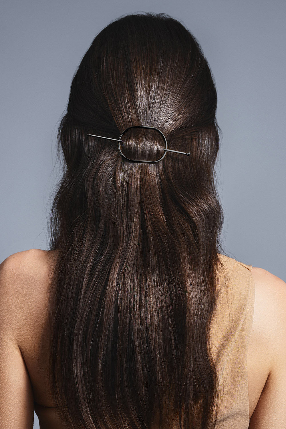 brunette model with a half up hair style using the hair edit's gunmetal hoop and pin barrette