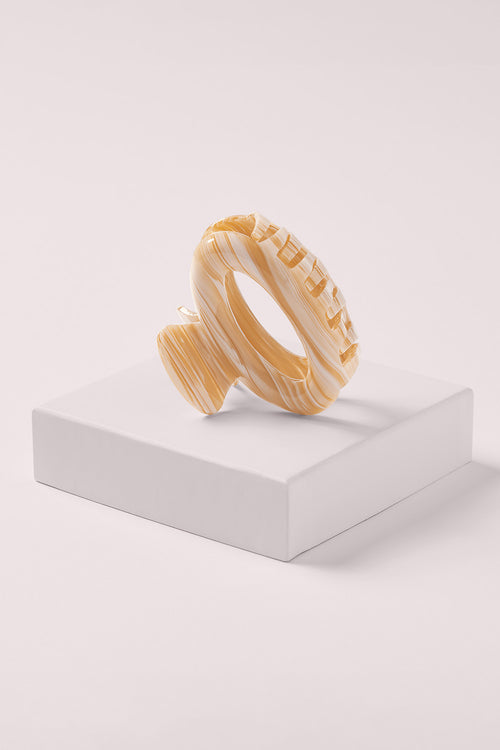 ellipse oval hair claw clip in caramel marble on white box