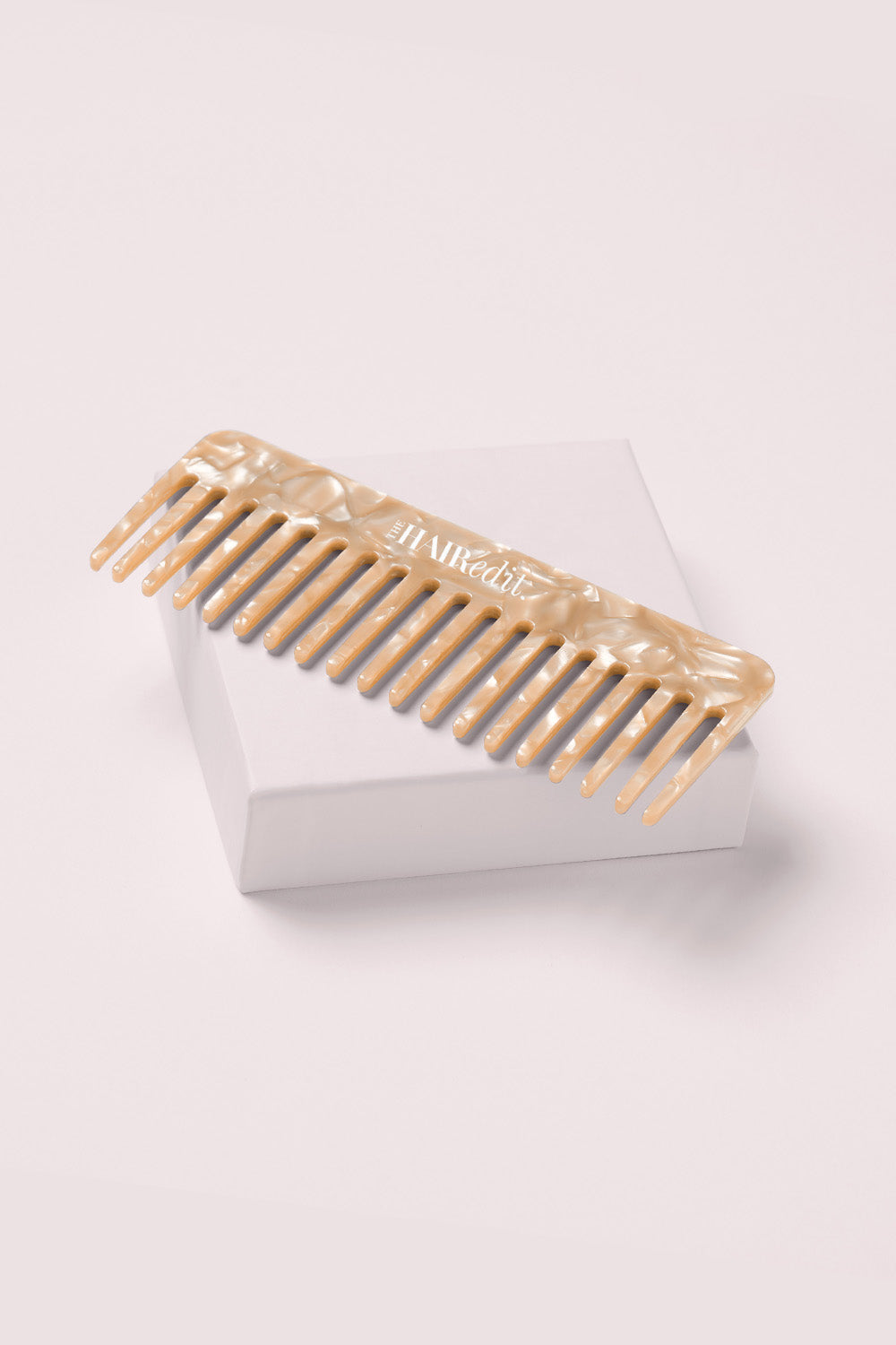 the hair edit untangle and glide beige comb on a box