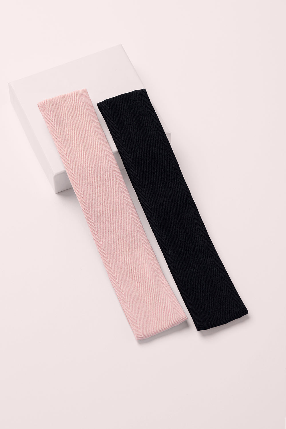 Two hairbands, one pink and one black, on a white background1