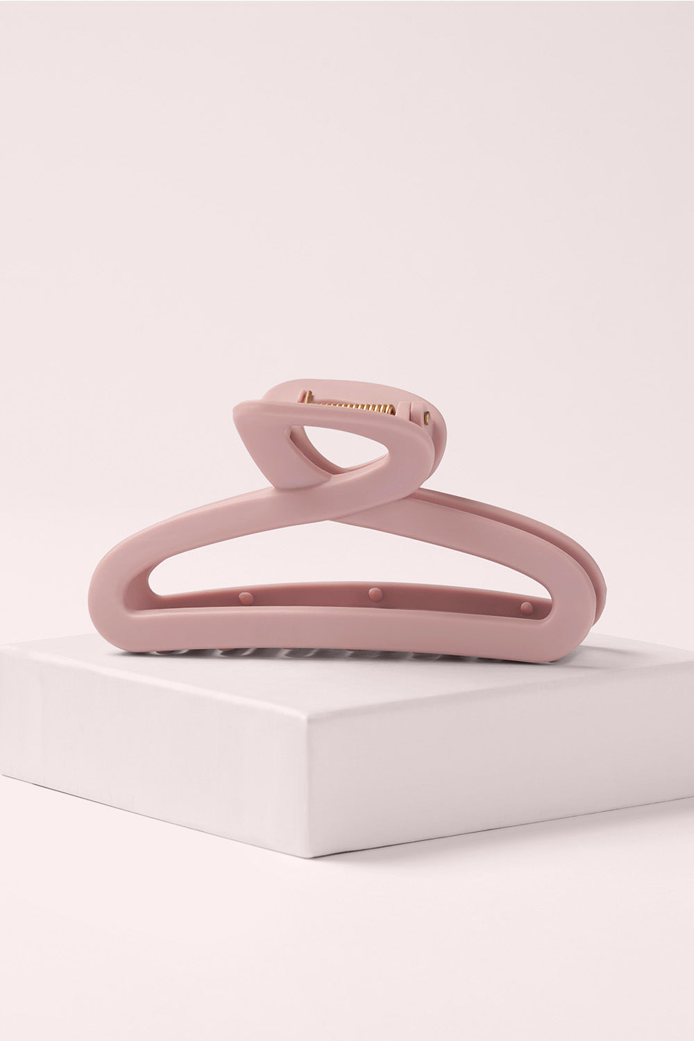 The Hair Edit Flexi Pink Soft Claw Clip on a light pink background1