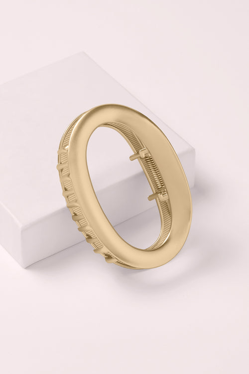 The Hair Edit Gilded Contour Claw Clip on a light pink background