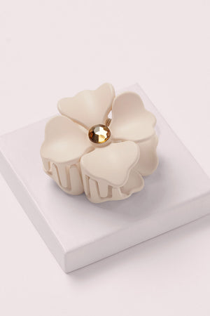 Camellia Rhinestone Flower Claw Clip on a pink box 