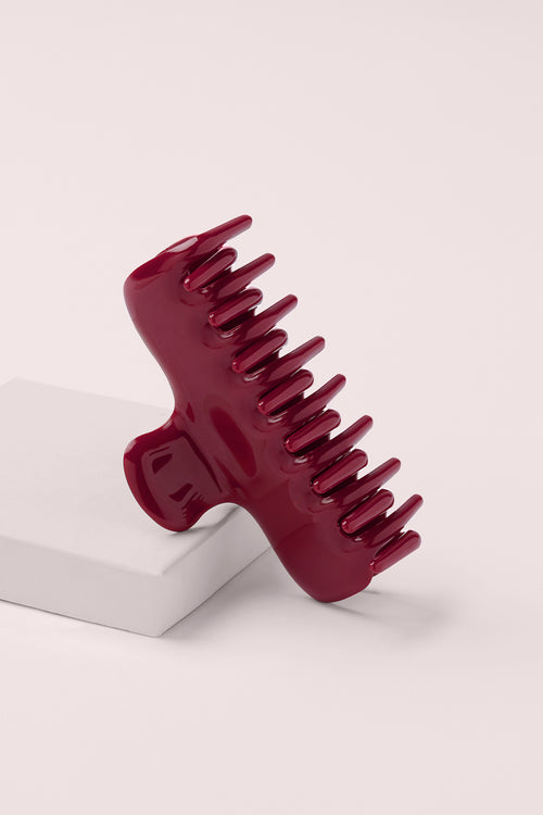 Scarlet Red Claw Clip on a pink background