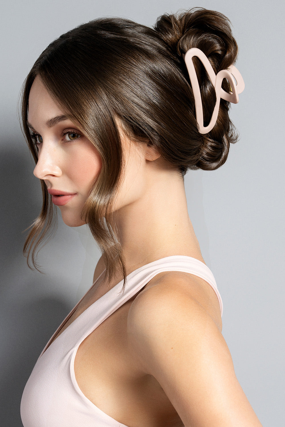 A brunette model wearing The Hair Edit Flexi Soft Claw Clip in her hair as a French twist3
