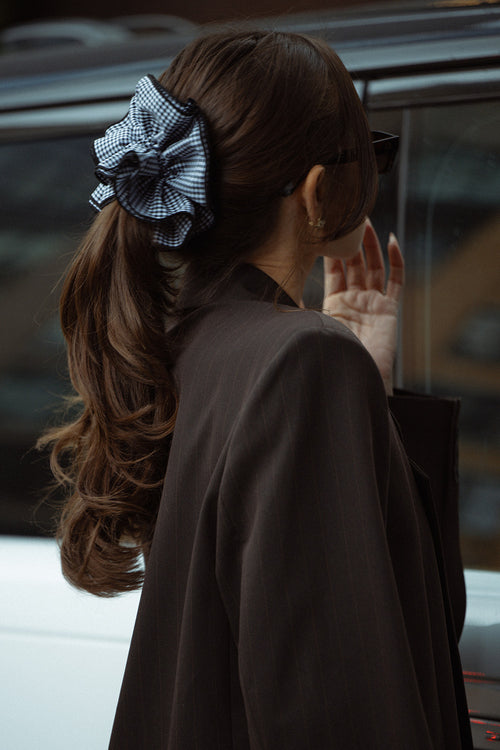 Danielle Bernstein wearing The Hair Edit’s Black and white gingham oversized ruffled scrunchie in the streets of nyc