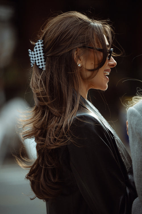 Danielle Bernstein wearing The Hair Edit’s Black and white gingham scalloped claw clip in the streets of nyc