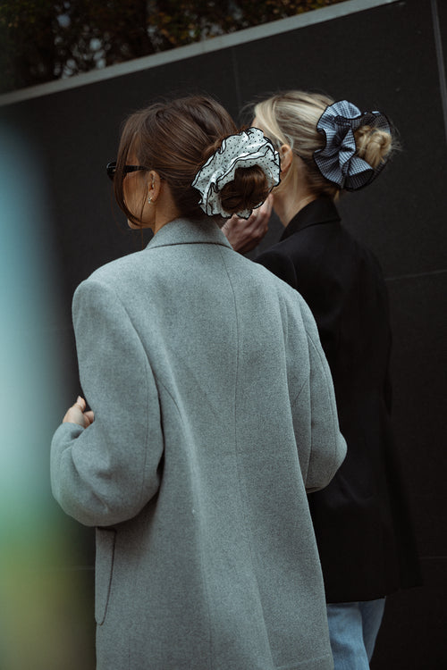 Danielle Bernstein wearing The Hair Edit’s White and black polka dot oversized scrunchie in the streets of nyc