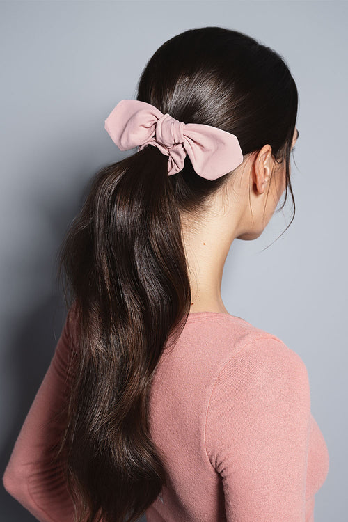 model with Bow Pose Knotted Ribbon Scrunchie in her hair 