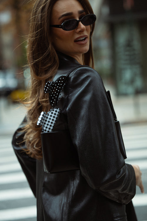 Danielle Bernstein wearing The Hair Edit’s claw clips clipped to her purse in the streets of nyc