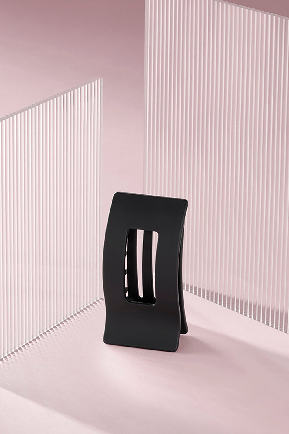 A black rectangle flat lay claw clip on a pink background5