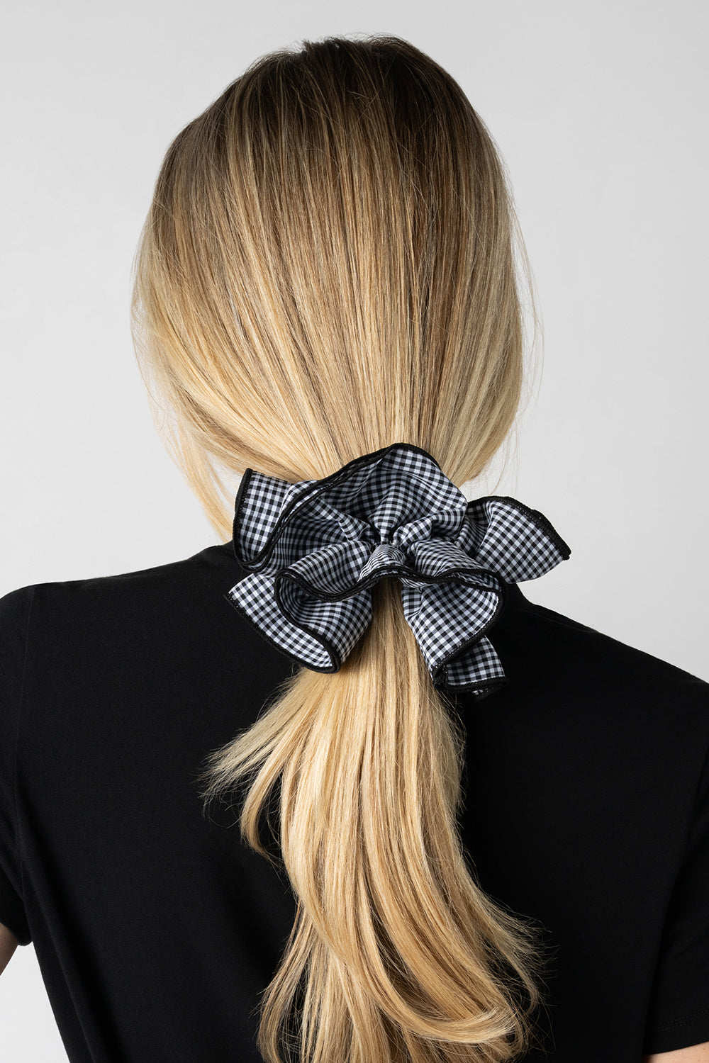 Blonde model wearing Black and white gingham oversized ruffled scrunchie in her hair5