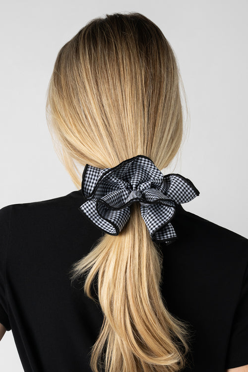 Blonde model wearing Black and white gingham oversized ruffled scrunchie in her hair