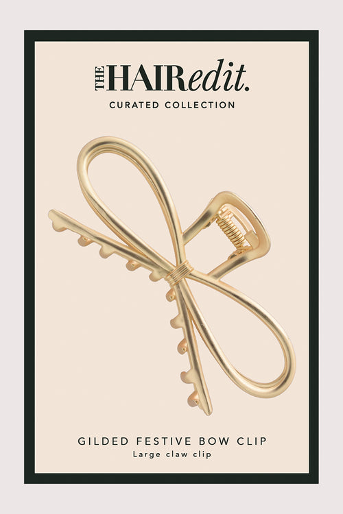 Gilded festive bow clip packaging with 'The Hair Edit' branding