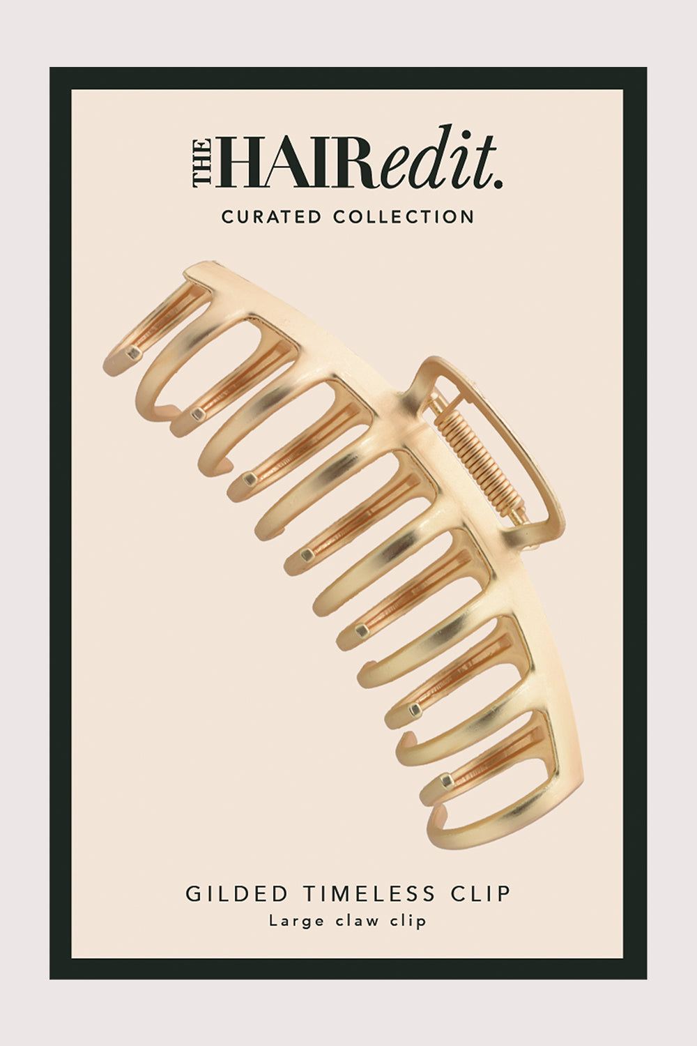 Gold hair clip on a beige background with 'The Hair Edit' branding.5