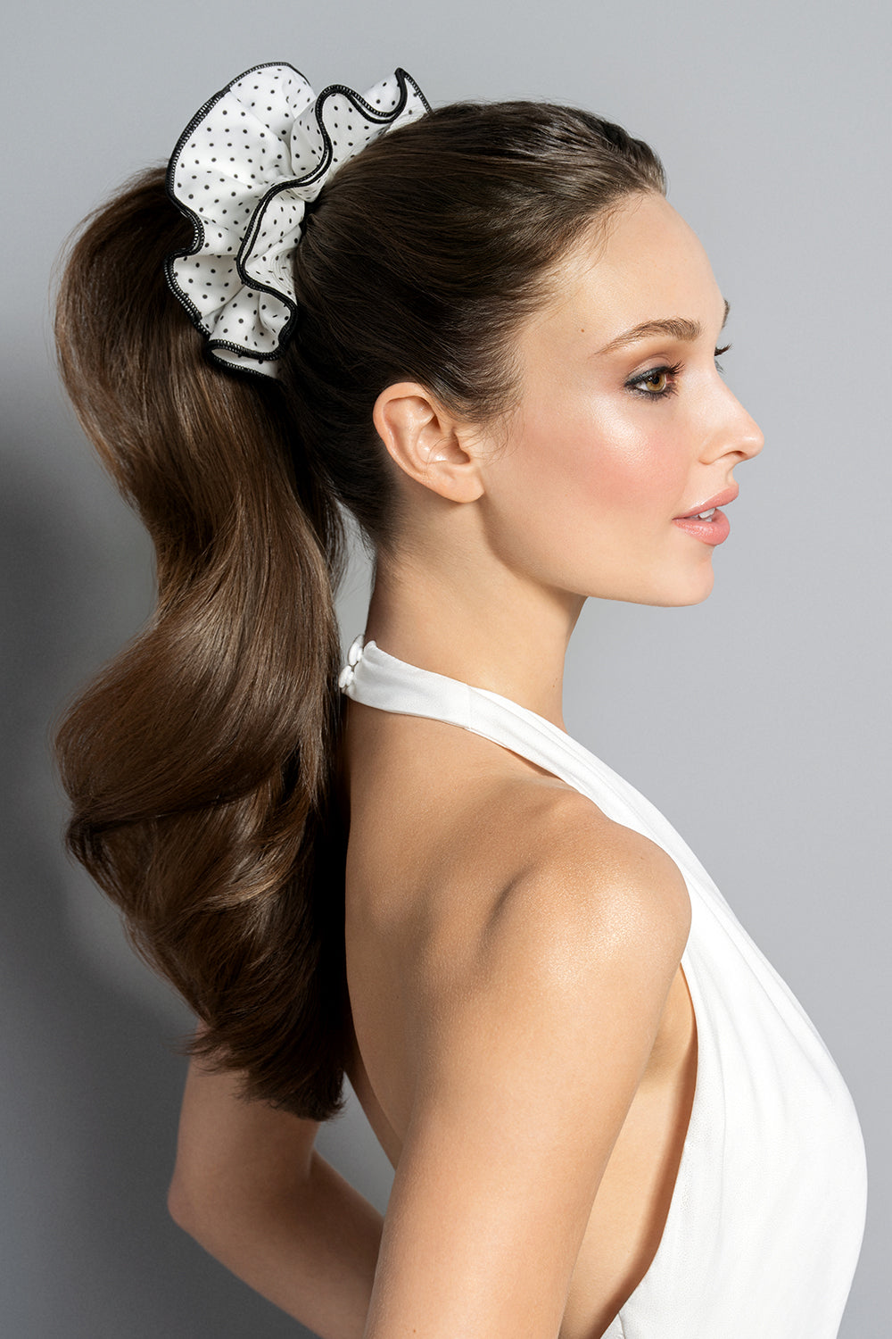 Brunette model wearing oversized scrunchie in her ponytail 7