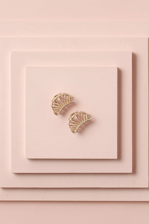 Petite Gilded Mermaid Claw Clips on a stack of pink boxes