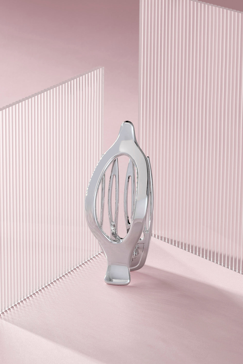 Silver flat flay claw clip on a pink background8