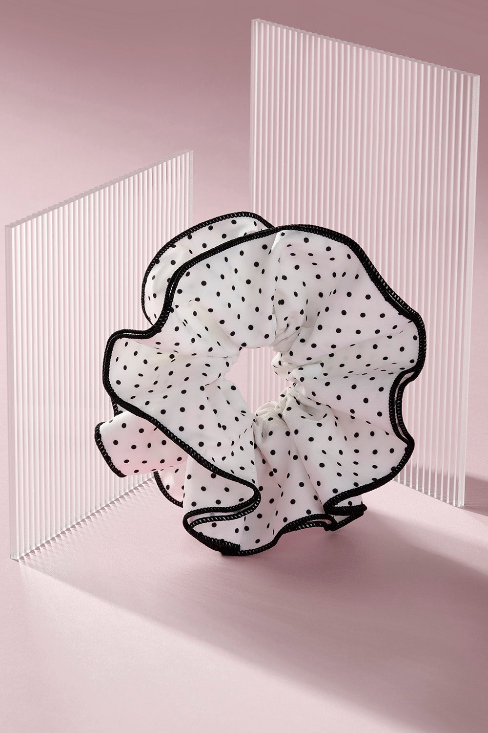 White and black polka dot oversized scrunchie on a pink background8