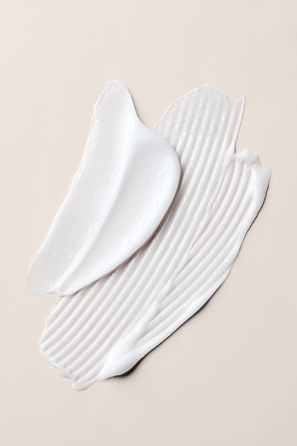 Close up of The Hair Edit Conditioner Concentrate creamy texture on a beige background8