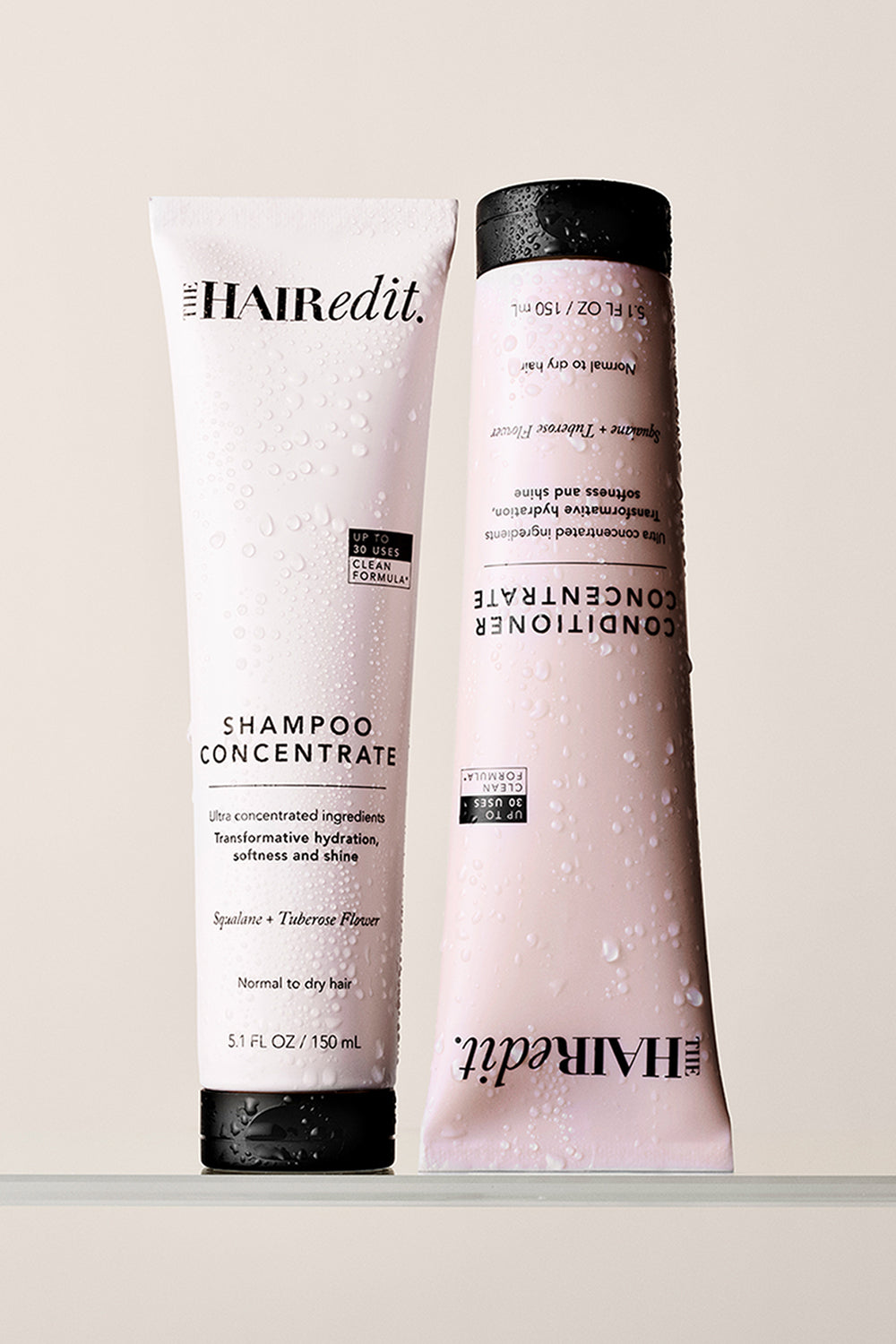 Two bottles of 'The Hair Edit' shampoo and conditioner on a light background12