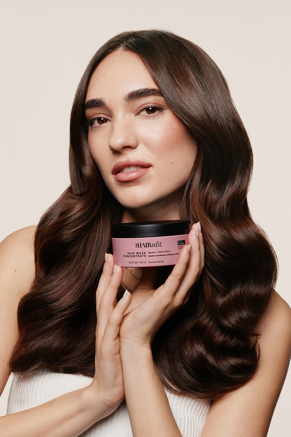 Model holding The Hair Edit’s Hair Mask Concentrated Jar in her hand10
