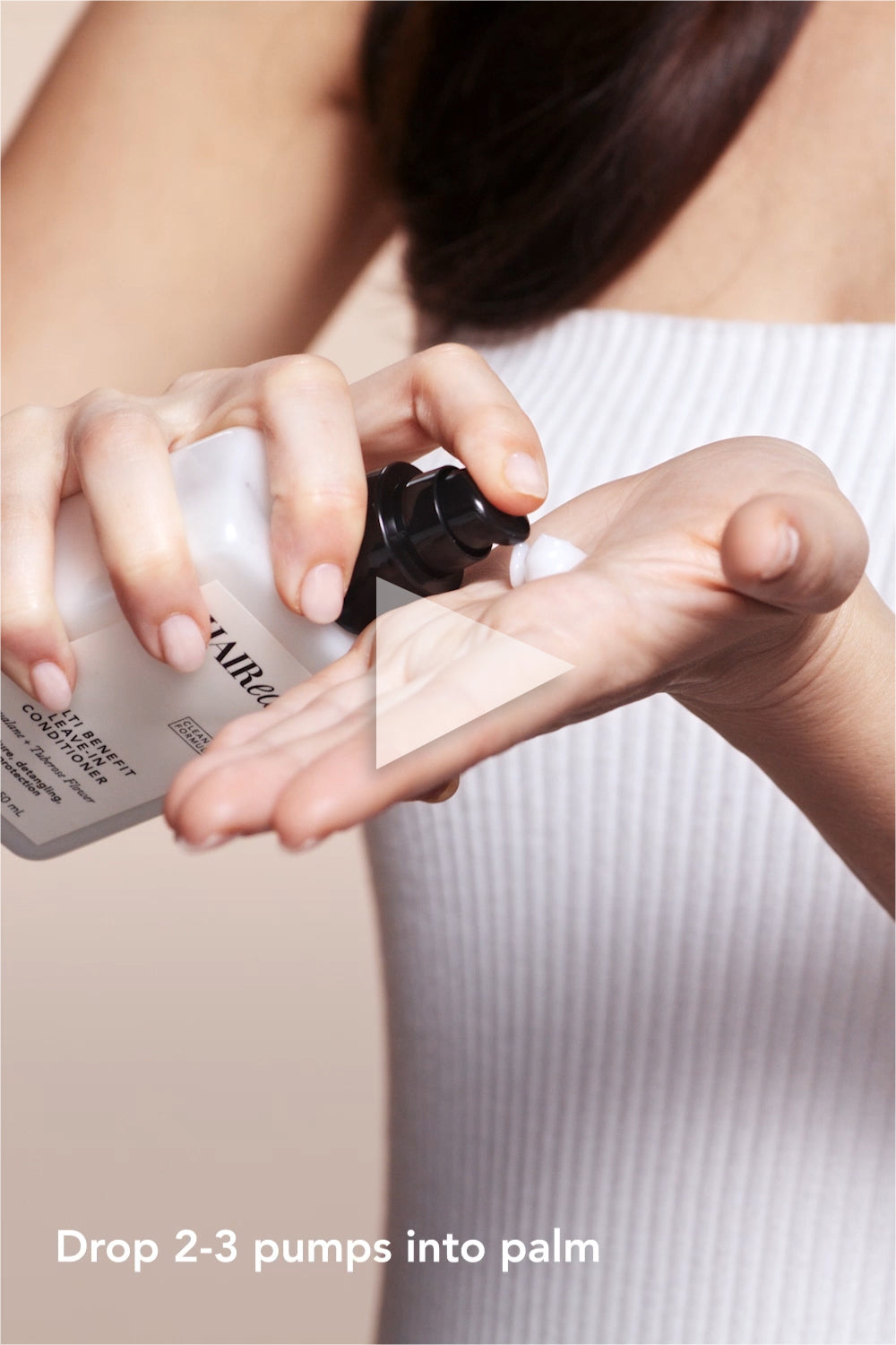 Video of model applying the Multi Benefit Leave-In Conditioner to her hair 2