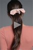 A video of a model putting Bow Pose Knotted Ribbon Scrunchie in her hair 