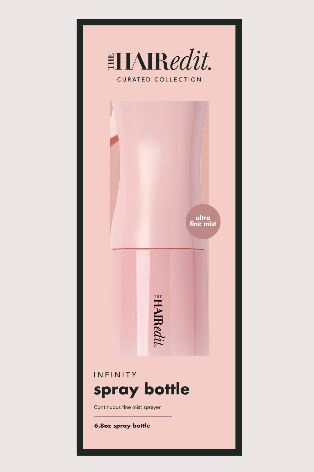 Pink spray bottle inside packaging with 'The Hair Edit' branding on a light pink background7